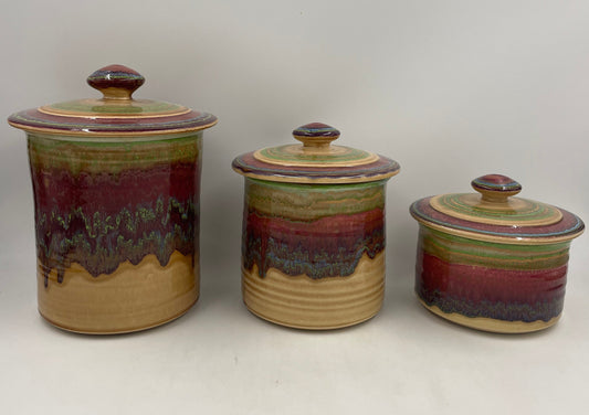 Set of 3 spanish ceramic stoneware canisters on white background