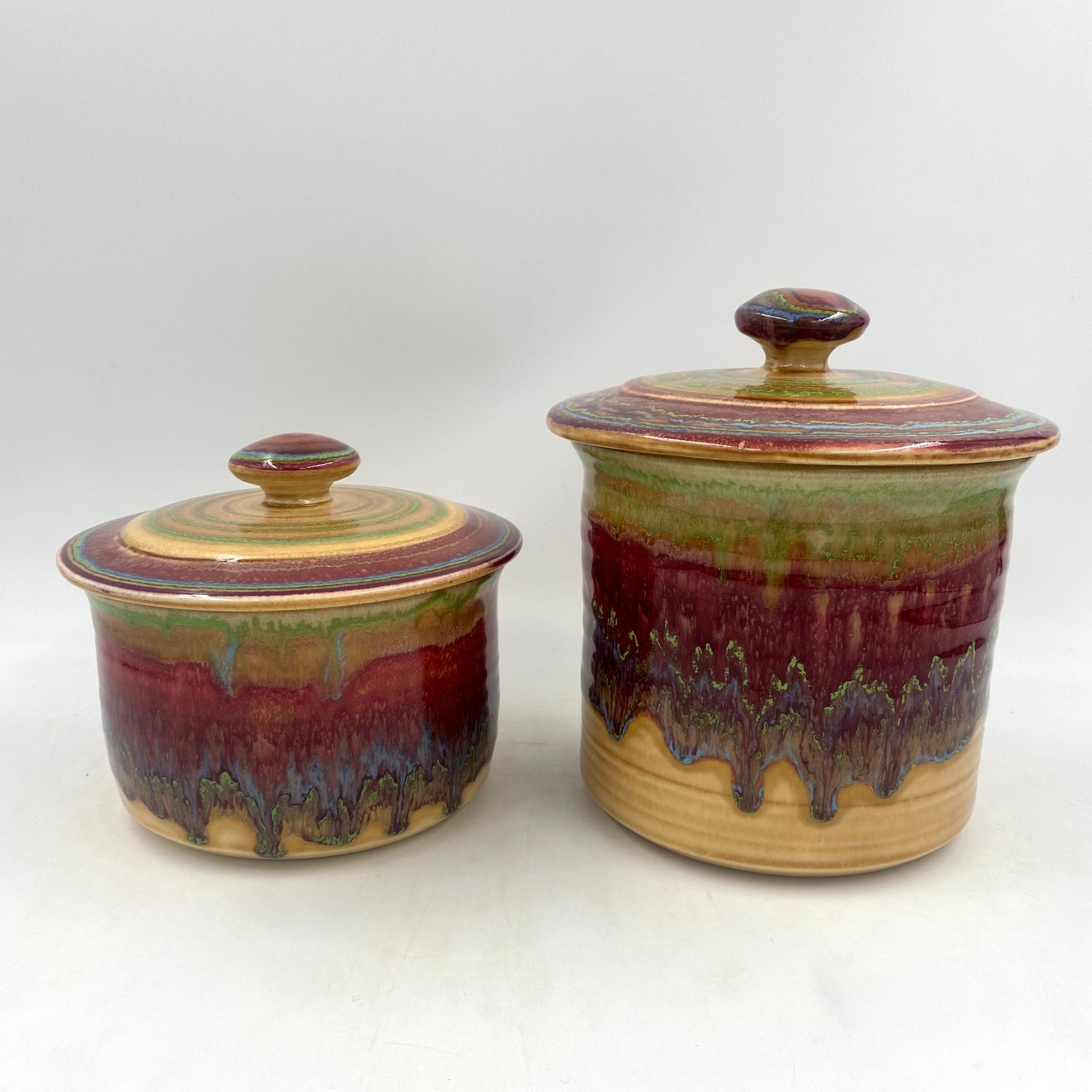 Small and medium size spanish canisters on white background